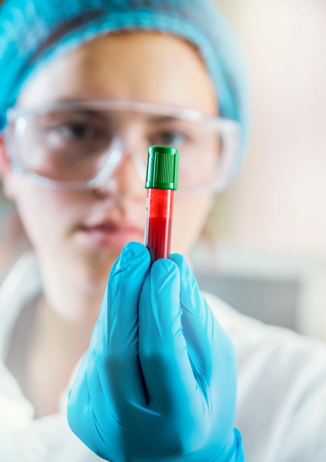 female examines blood tube female examines blood tube