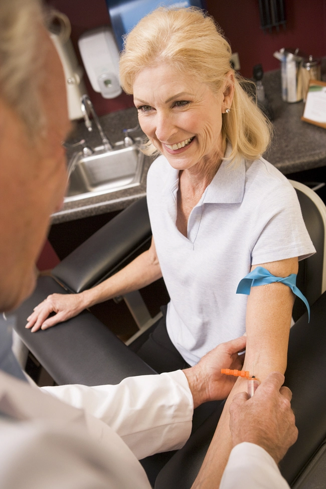 female patient getting blood check from male doctor