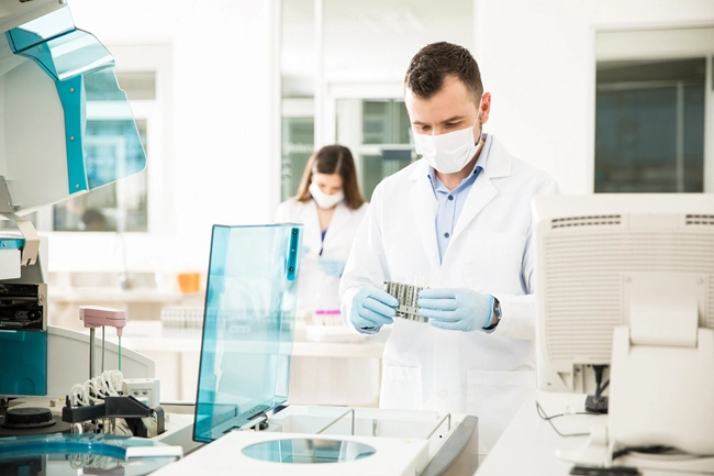 male doctor analyzing blood samples in lab