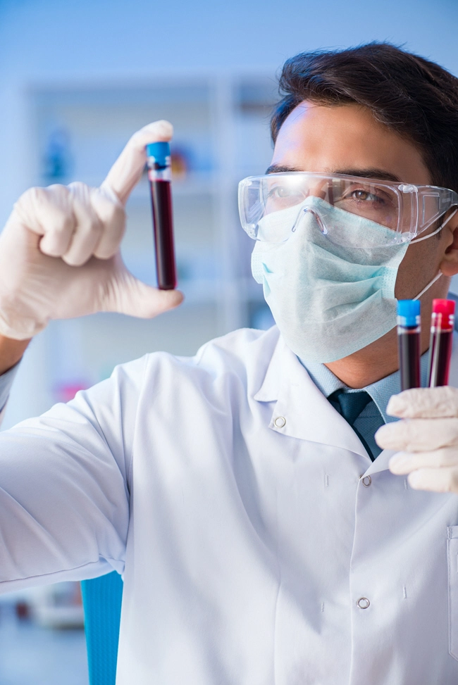 male doctor examines blood sample male doctor examines blood sample