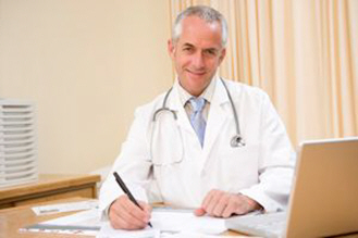 doctor with laptop writing in doctors office xs doctor with laptop writing in doctors office xs