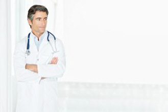 male doctor with arms folded looking at copy space xs male doctor with arms folded looking at copy space xs