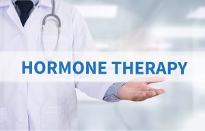 Doctor holding hormone therapy sign 300x192