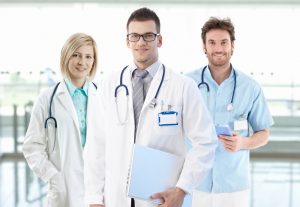 portrait of smiling young doctors on hospital corridor looking at camera 109530050 300x207