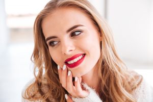 graphicstock close up portrait of a smiling attractive woman with red lipstick indoors SBI 302779574 300x200