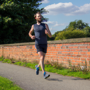 a professional appealing image of a caucasian man or woman jogging on a sunny day