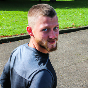 a professional appealing good looking and atheletic image of a caucasian man exercising or playing sports outside on a sunny day